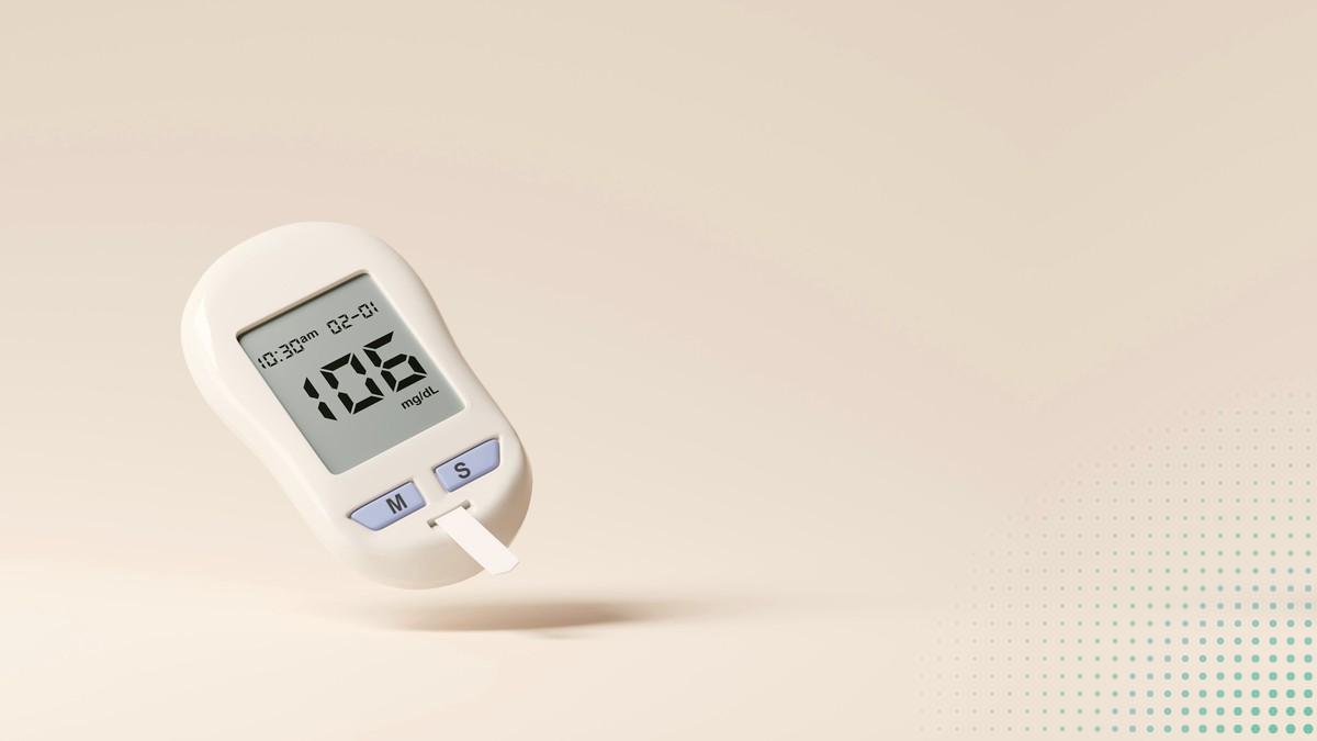 A glucose meter on a beige ground